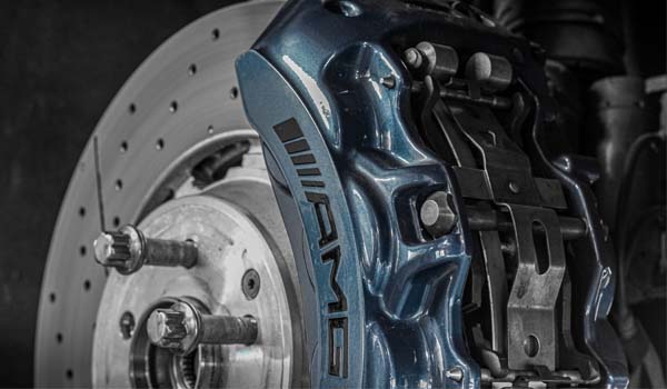 blue AMG caliper and silver slotted brake disc