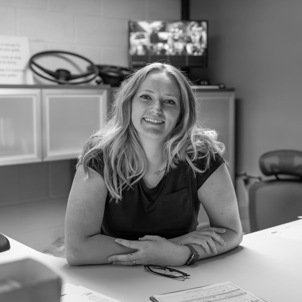 close up black and white portrait photo of the marketing coordinator of an automotive company, in celebration of International Women's Day. 
